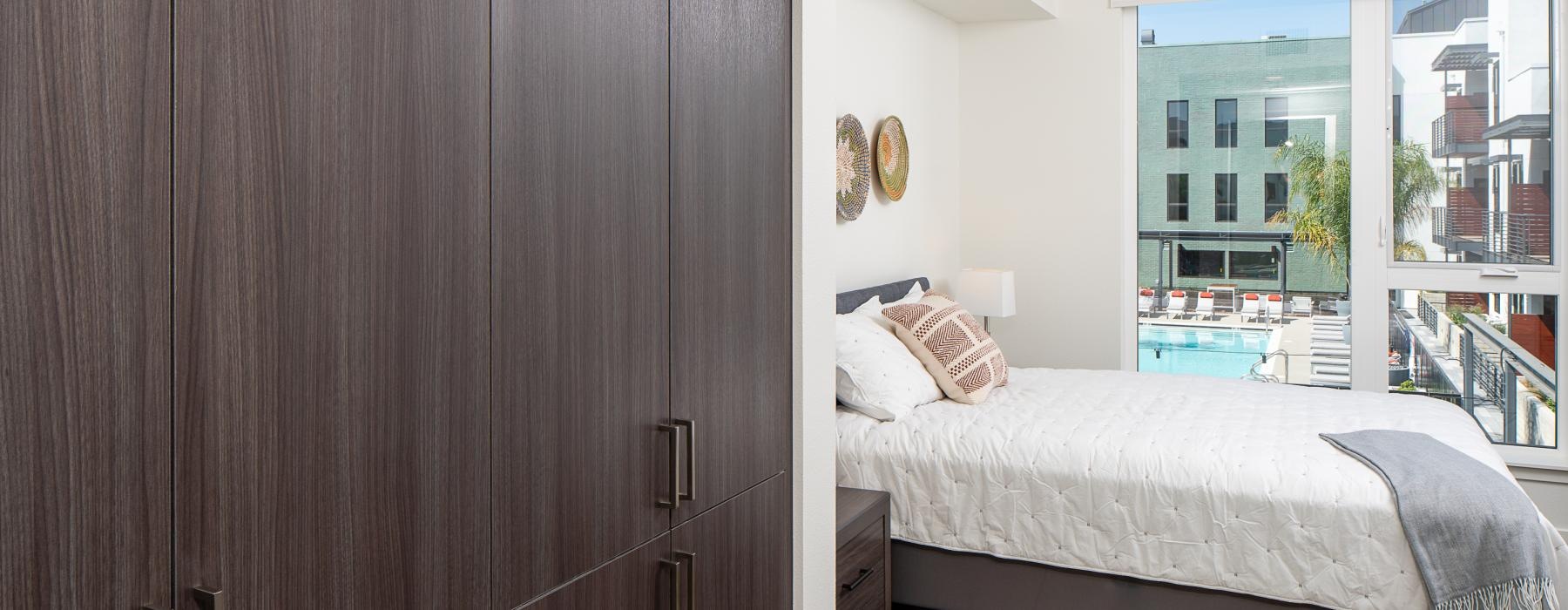 a bedroom with a bed and a large window