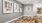 a hallway with a rug and a wall with pictures on it