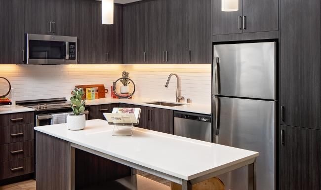 a kitchen with a table and a refrigerator